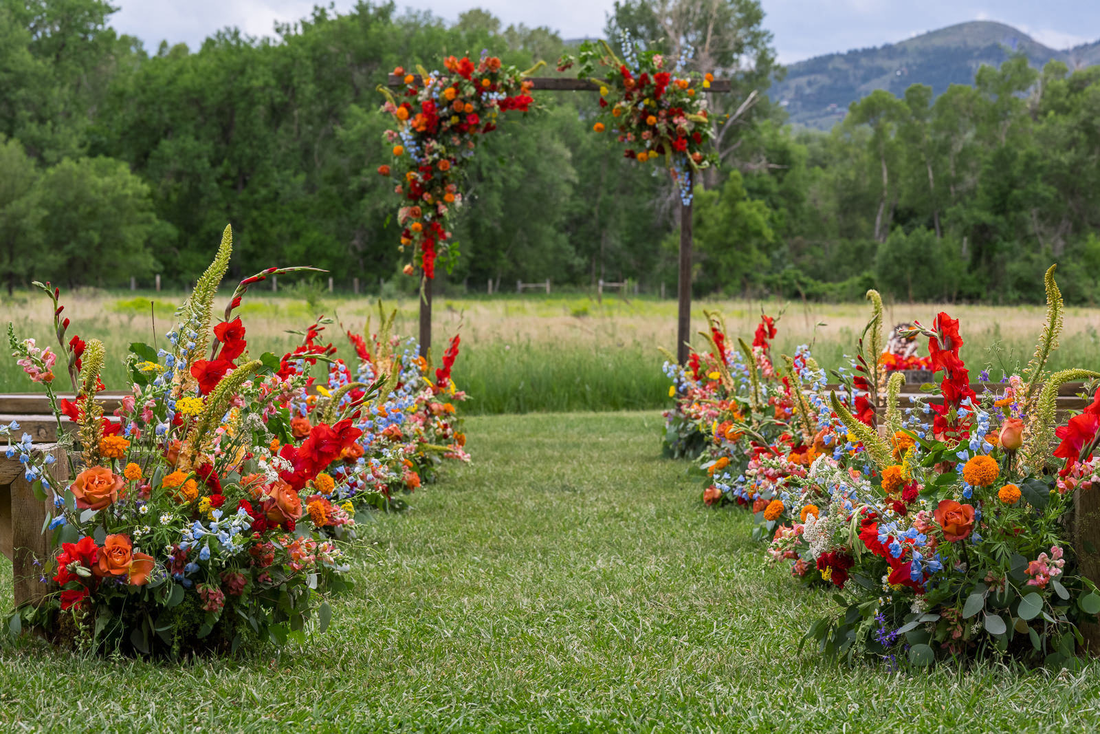 vibrant colorado wedding flowers for aisle and ceremony